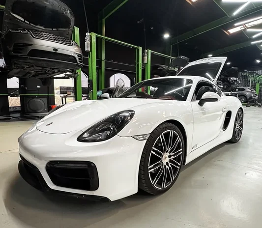 Porsche Cayman GTS exterior and wheel detail in the Dubai workshop